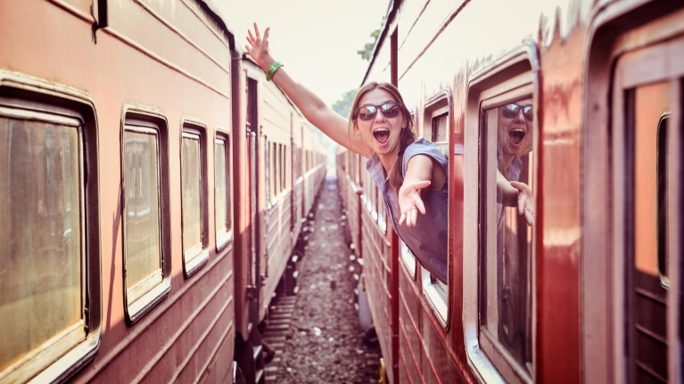 cheerful woman on train 1920 x 1080