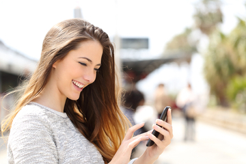 girl-on-phone-at-train-station