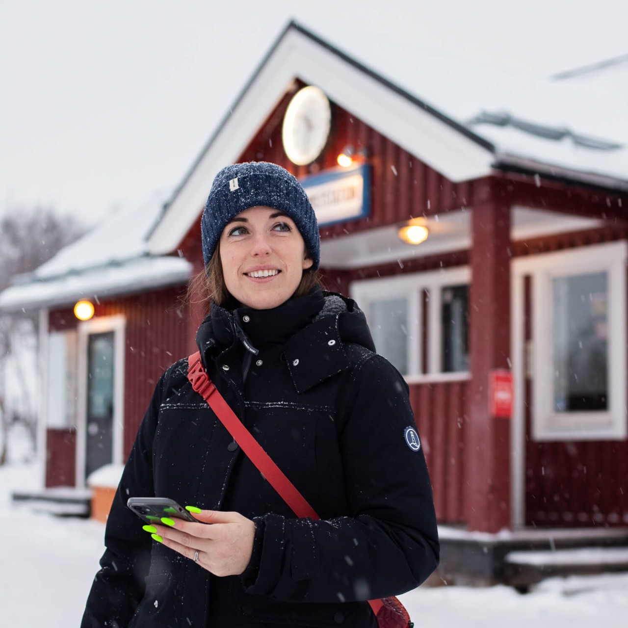 Rachel Schnalzer stands outside a train station in Abisko Sweden