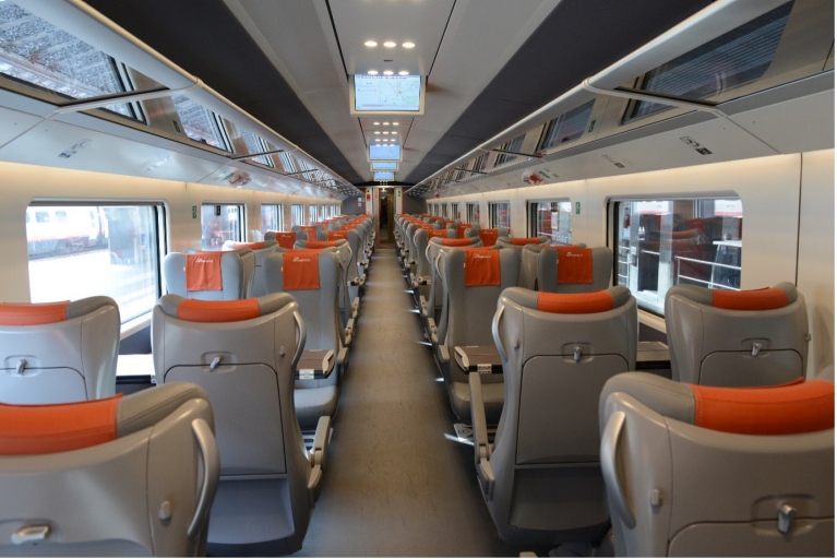 Luggage and tv screen in Le Frecce train