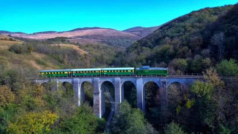 Train crossing a bridge in Romania