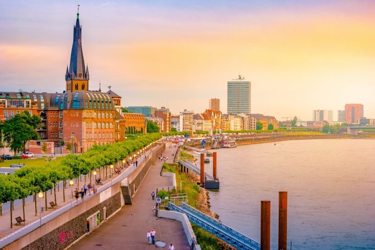 Landscape of Dusseldorf's skyline and river at sunset 