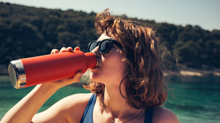 girl-drinking-from-reusable-water-bottle-sustainable